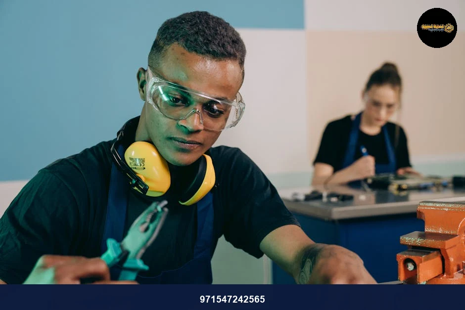 Two technicians carefully working with tools in a modern workshop.