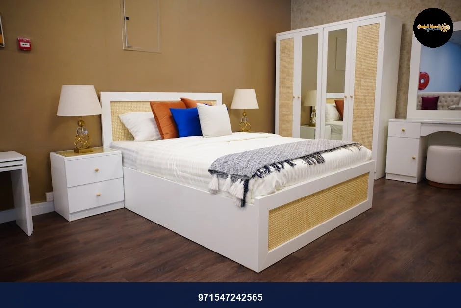 A stylish bedroom with elegant white furniture and cozy decor.