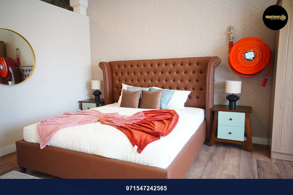 Elegant bedroom with tufted leather headboard and cozy decor in neutral tones.