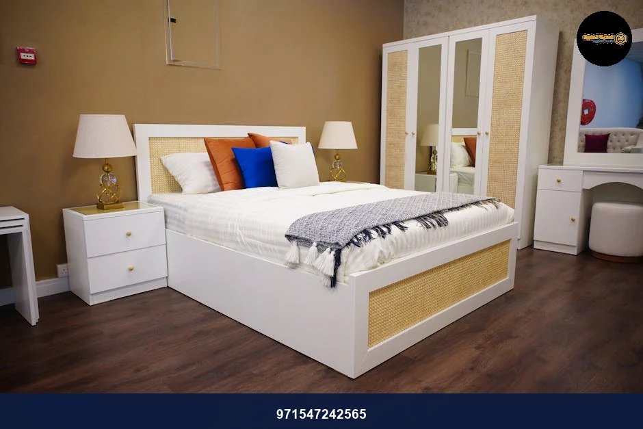 Elegant bedroom with modern white furniture, cozy textiles, and warm lighting.