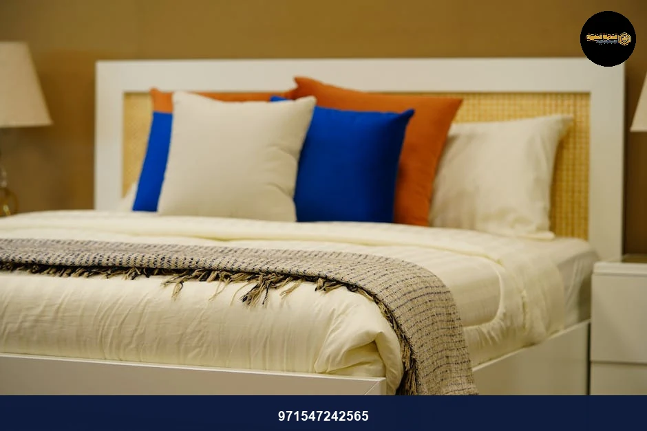 A stylish modern bedroom featuring vibrant pillows, soft textures, and warm ambiance in elegant decor.