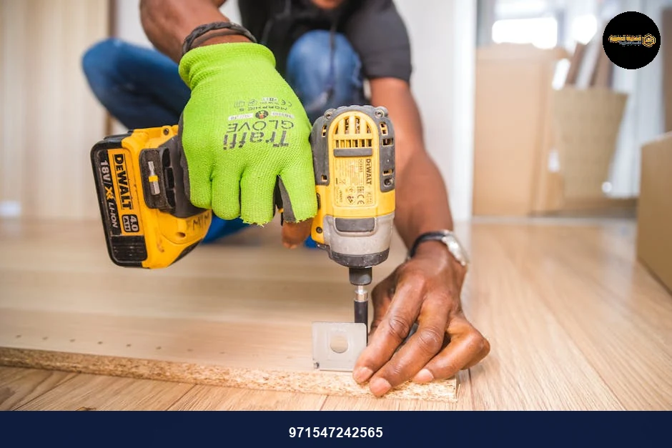Man using a power drill for home improvement on a wooden floor with precision.
