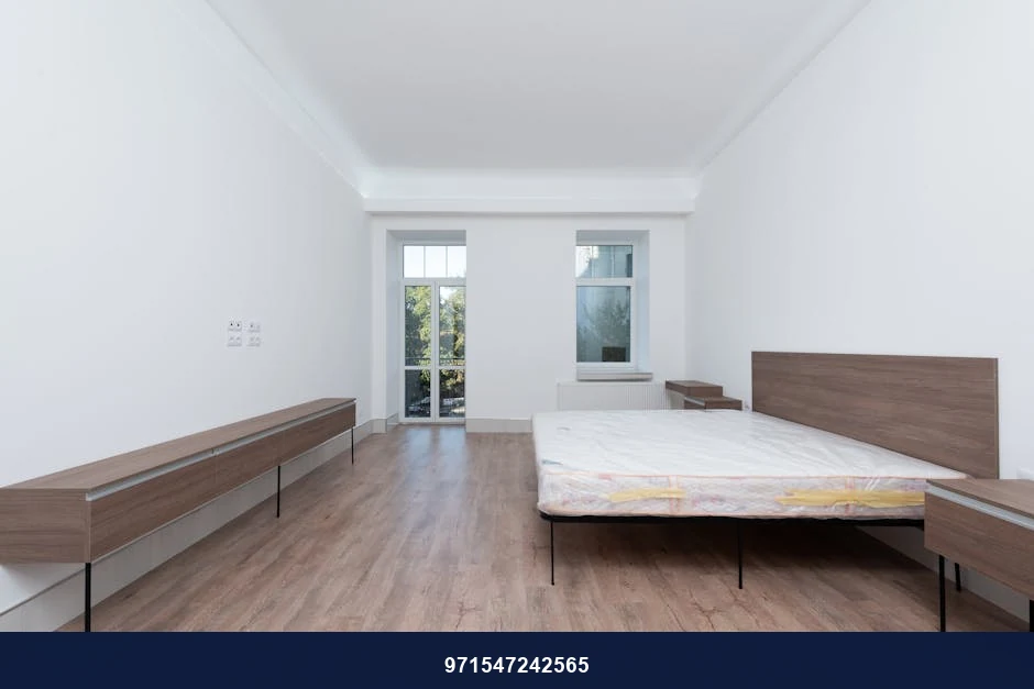 Spacious minimalist bedroom with wooden furniture and matte finish. Spacious minimalist bedroom with wooden furniture and matte finish.