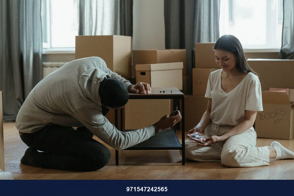A couple assembling a coffee table amid stacked moving boxes in their new home. A couple assembling a coffee table amid stacked moving boxes in their new home.