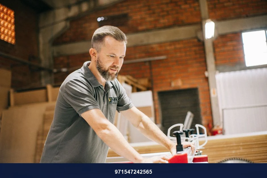 Carpenter using a table saw in a workshop, focusing on precise cuts on wood.