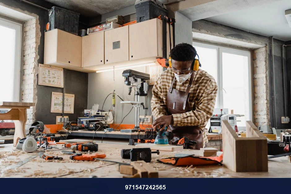 A skilled craftsman working with tools in a well-equipped woodworking workshop.