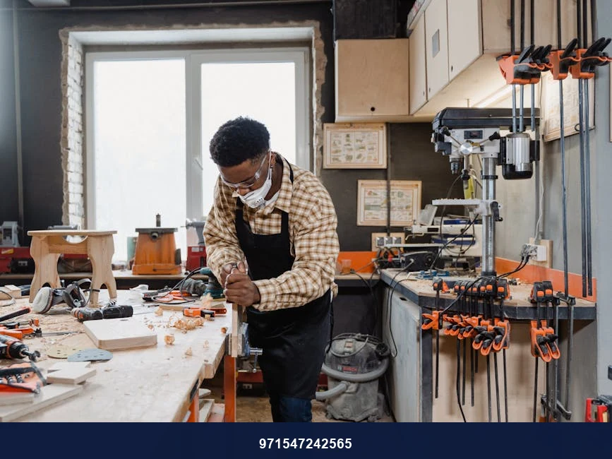 A dedicated carpenter wearing a facemask crafting wood in a workshop.