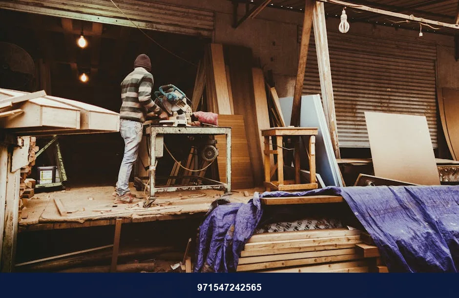 Carpenter focused on woodworking inside a cozy, rustic workshop.