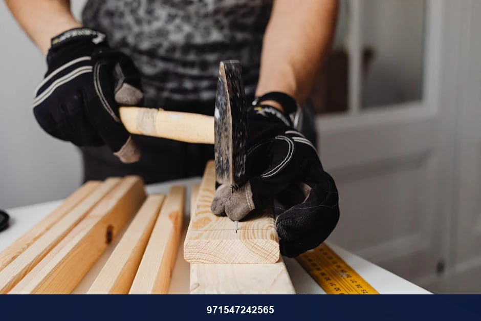 Craftsman hammering nails into wood, showcasing woodworking skills and tools in action.