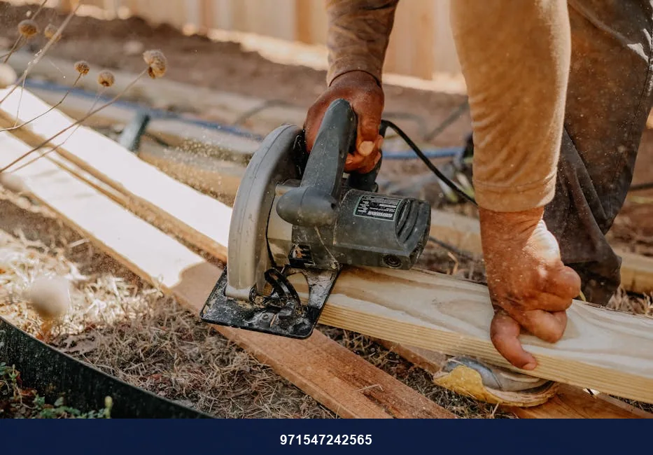 Carpenter operating a circular saw on wooden planks outside, showcasing woodworking skills.