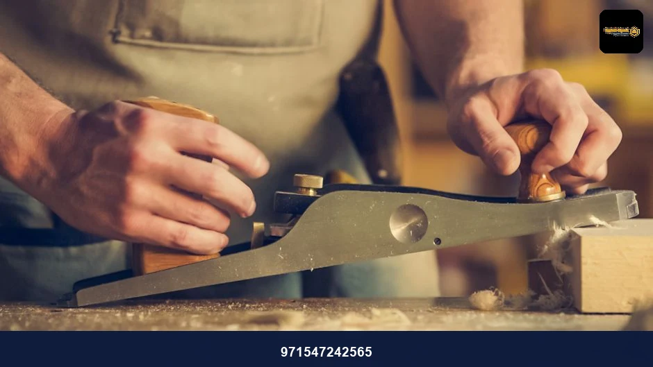 A carpenter skillfully using a hand plane on a wooden surface indoors. A carpenter skillfully using a hand plane on a wooden surface indoors.