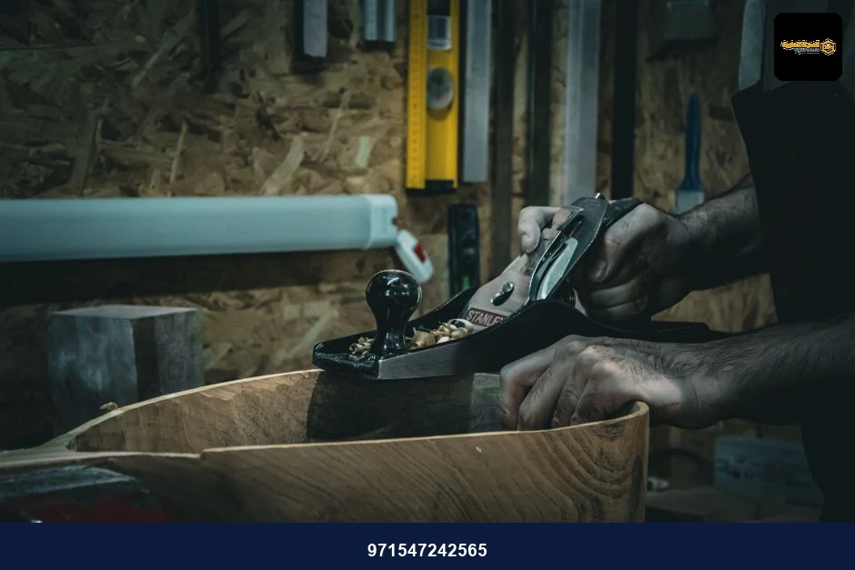 Close-up of craftsman smoothing wood with a hand plane in a workshop, emphasizing skilled carpentry. Close-up of craftsman smoothing wood with a hand plane in a workshop, emphasizing skilled carpentry.