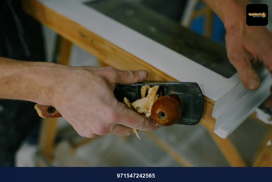 From above of crop anonymous joiner cutting wooden frame with manual jack plane at work From above of crop anonymous joiner cutting wooden frame with manual jack plane at work