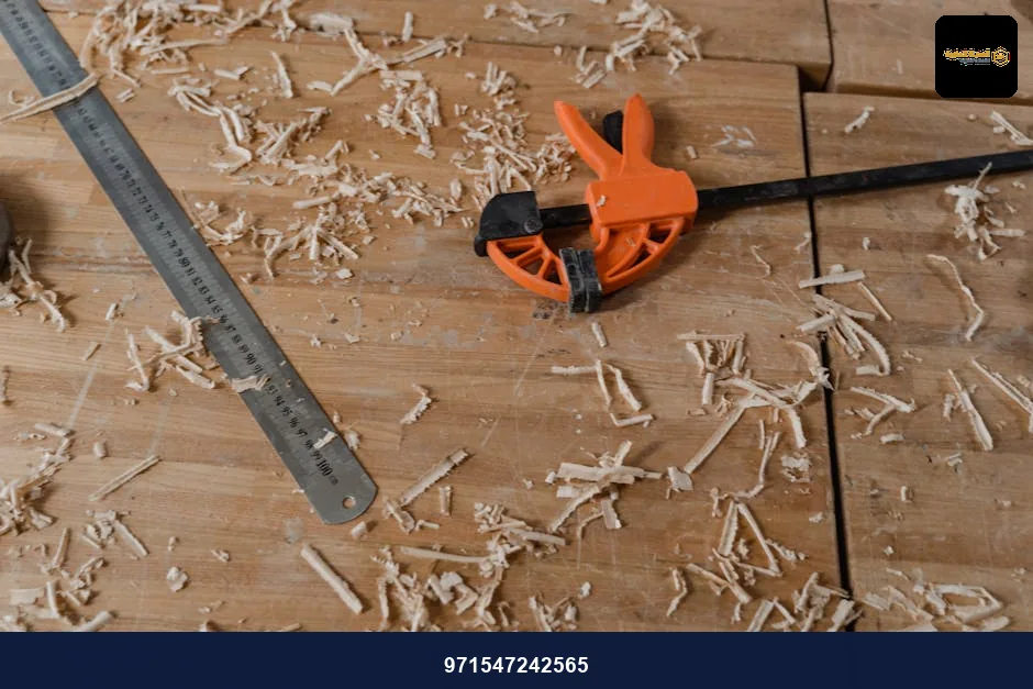 Close-up of woodworking tools on a wooden workbench with scattered sawdust. Close-up of woodworking tools on a wooden workbench with scattered sawdust.