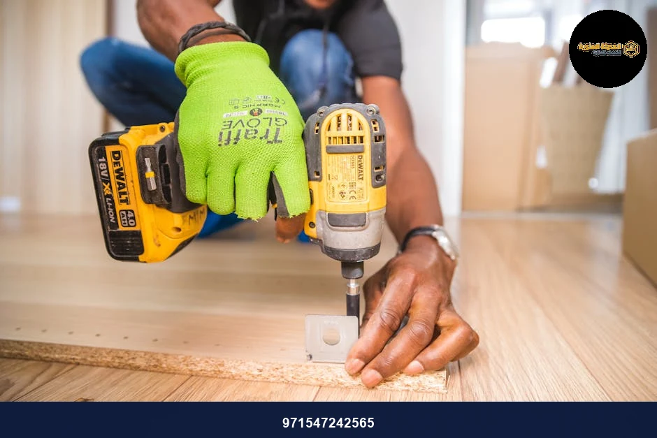 Man using a power drill for home improvement on a wooden floor with precision.