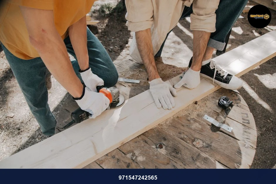 Two young carpenters using electric tools on a wooden plank outdoors. Practical DIY woodworking scene.
