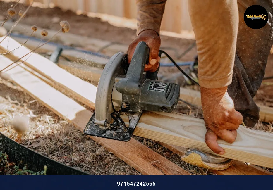 Carpenter operating a circular saw on wooden planks outside, showcasing woodworking skills.