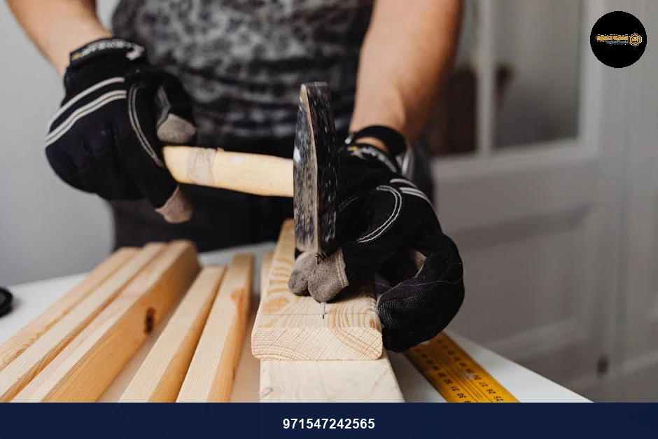 Craftsman hammering nails into wood, showcasing woodworking skills and tools in action.