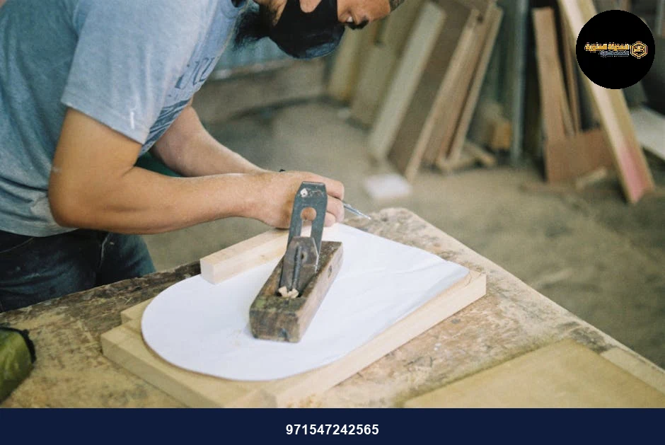 Carpenter woodworking with a hand plane on a wooden surface indoors. Carpenter woodworking with a hand plane on a wooden surface indoors.