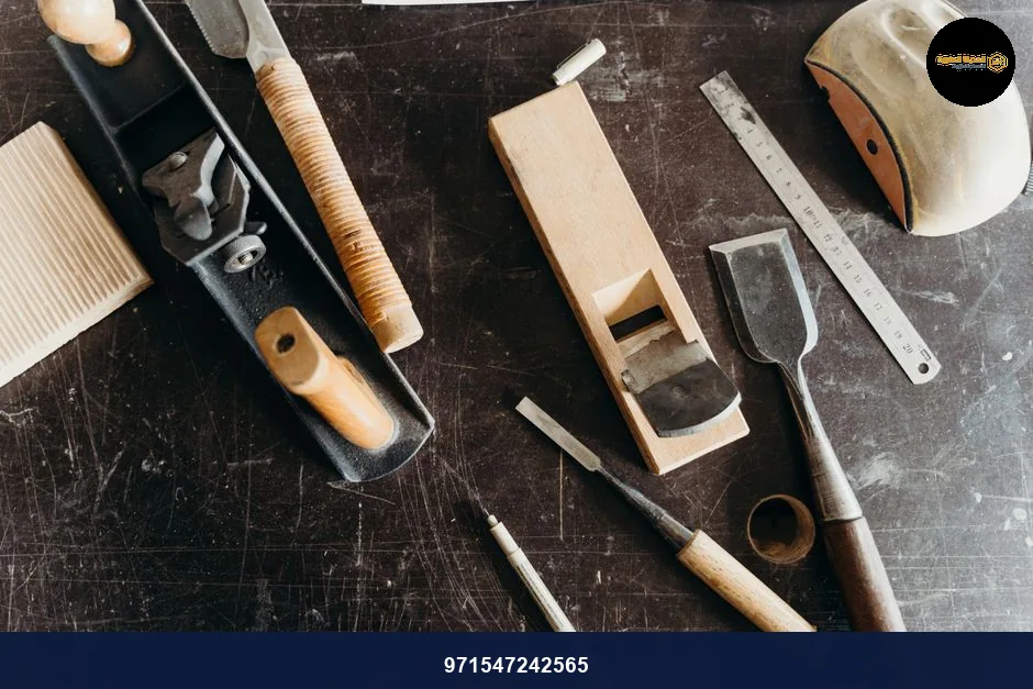 A collection of woodworking tools on a workshop table, showcasing craftsmanship essentials.