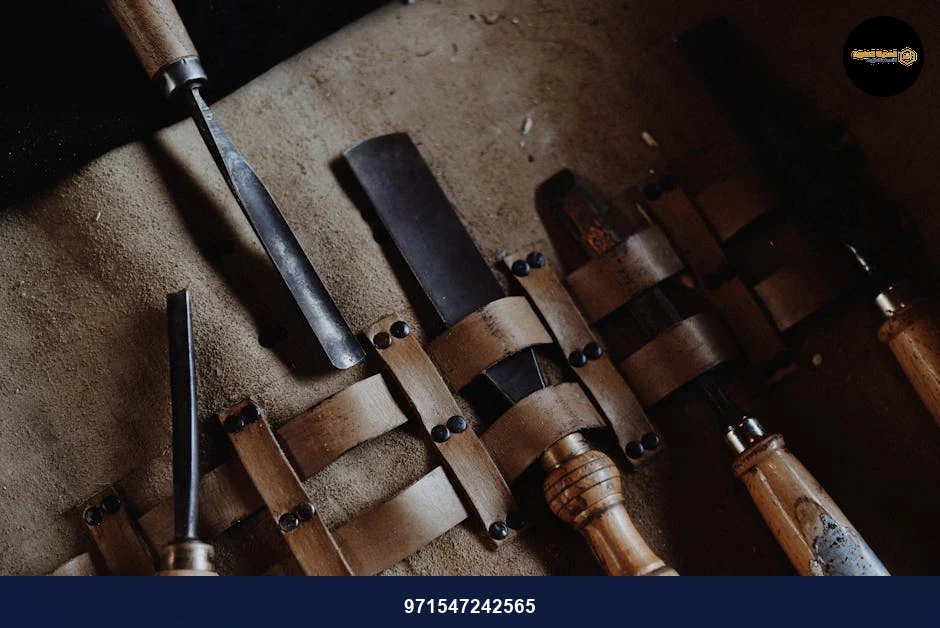 Set of vintage woodworking chisels neatly arranged on a rustic leather mat, showcasing craftsmanship.