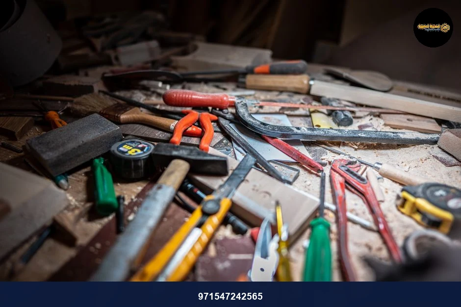 Close-up of a cluttered workbench with various carpentry tools and equipment.