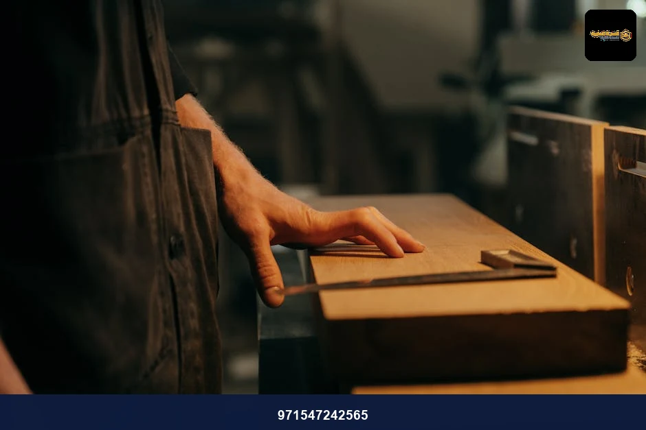 A craftsman measuring wood with precision tools in a workshop setting. A craftsman measuring wood with precision tools in a workshop setting.
