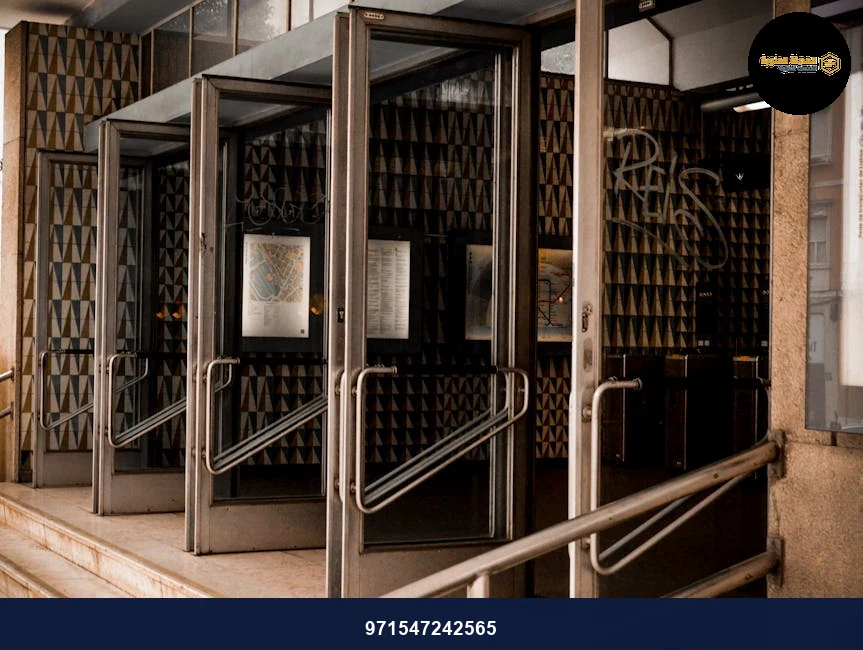 Glass doors of a modern building showing geometric patterns and reflections. Glass doors of a modern building showing geometric patterns and reflections.