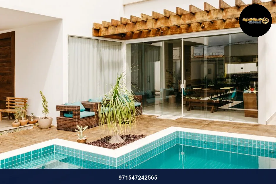 Contemporary poolside patio with elegant seating and lush plants for a relaxing outdoor experience. Contemporary poolside patio with elegant seating and lush plants for a relaxing outdoor experience.