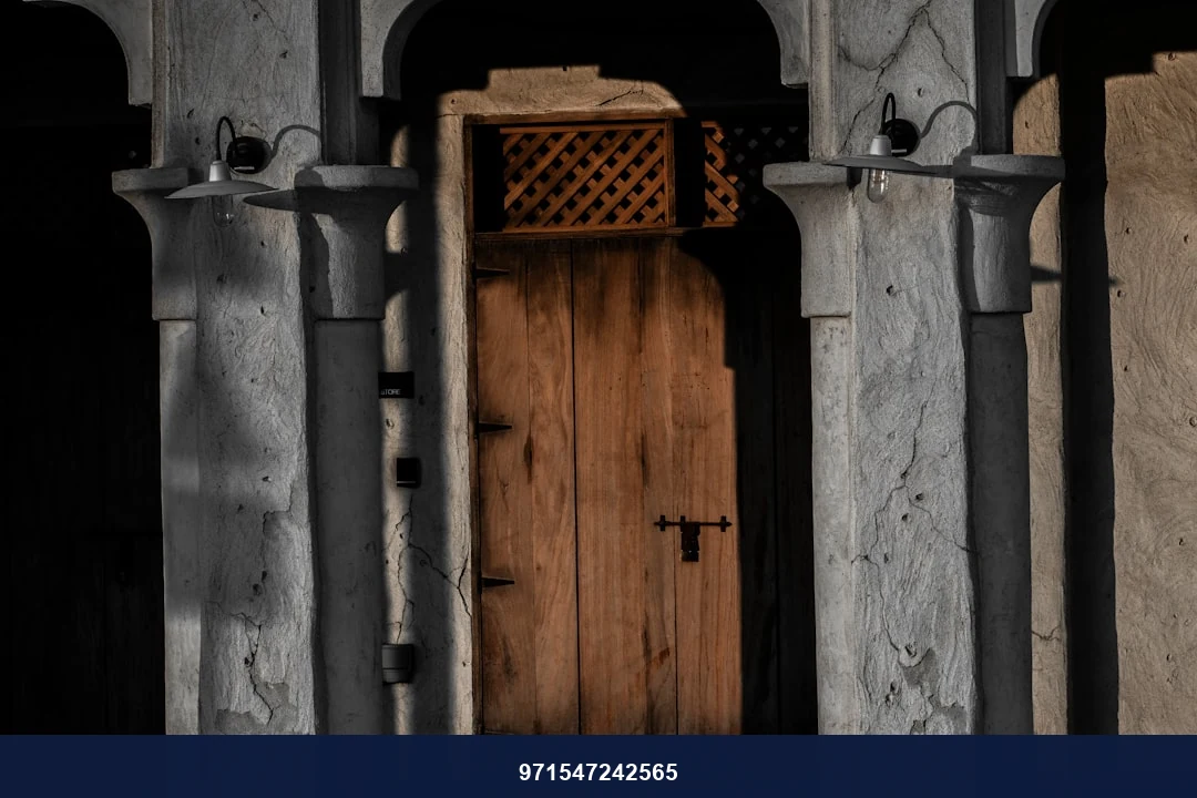 a wooden door sitting between two stone pillars