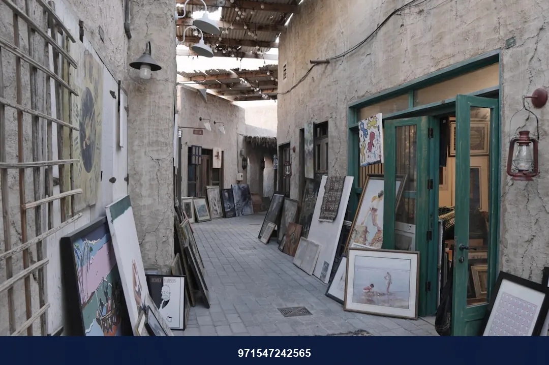 an alley way with a bunch of paintings on display