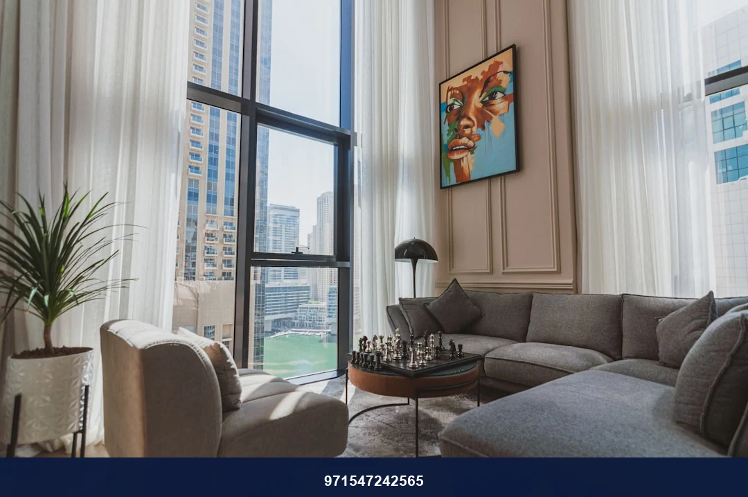 a living room filled with furniture and a large window