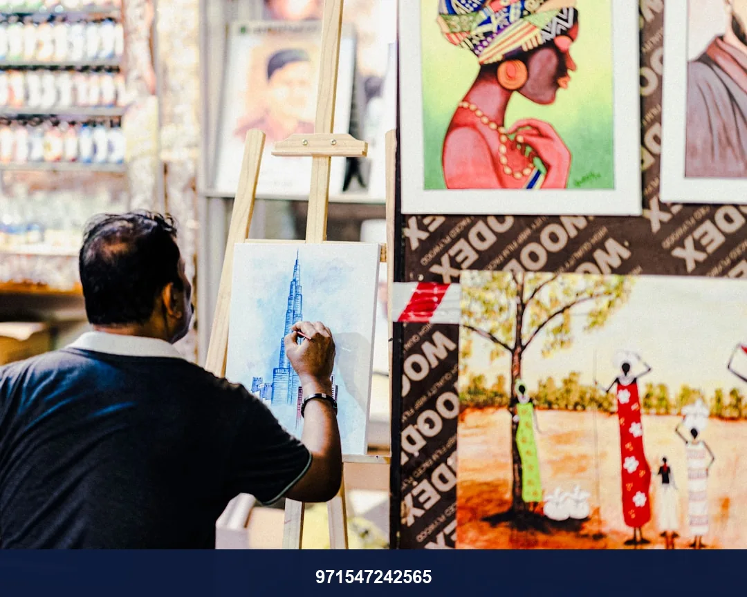 a man is painting pictures on a canvas